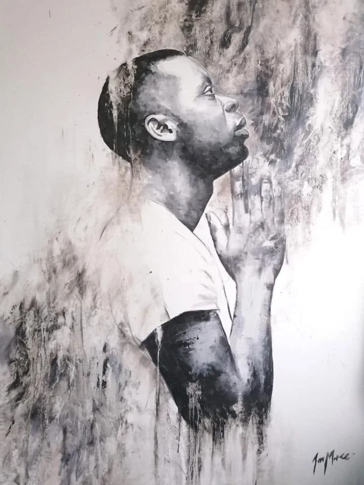 Monochrome profile of a man with hands held together